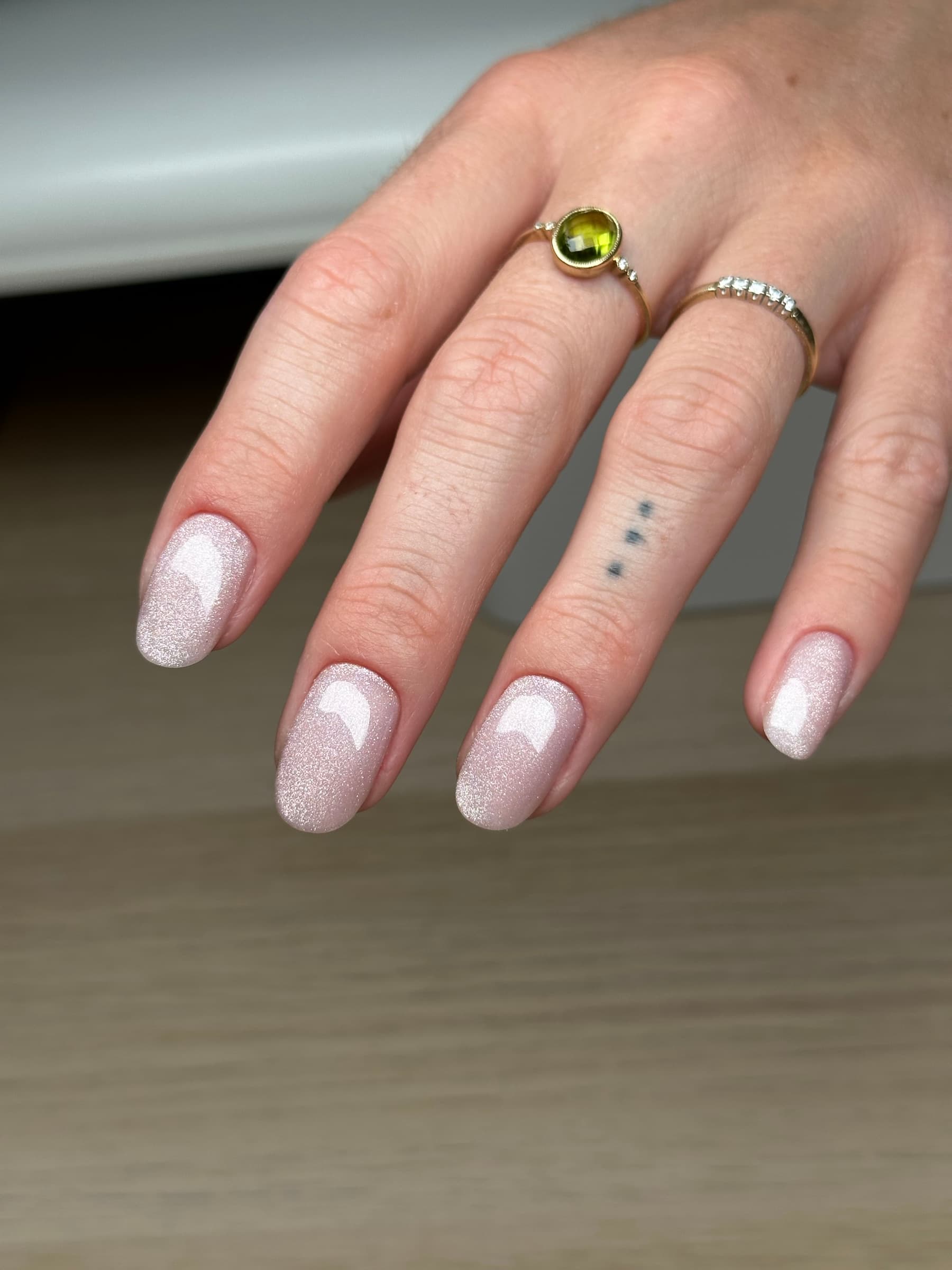 Shimmering iridescent pink glitter manicure on oval nails